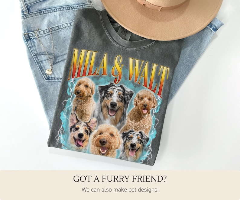 May include: A charcoal gray t-shirt featuring the text "MILA & WALT" in a retro font with a lightning bolt design. The shirt showcases a collage of six different dog breeds. A tan hat and blue jeans are also in the image.
