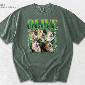 Pu&ograve; includere: T-shirt verde muschio con la scritta "OLIVE" in un font sfumato verde. La maglietta presenta una grafica di sei gatti con varie marche, su un design a fulmine verde. La maglietta &egrave; di colore design n. 4.
