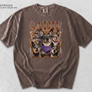 May include: An espresso-colored short-sleeve t-shirt featuring a graphic print of five Australian Cattle Dogs. The text SADIE is printed in large brown letters above the dogs, and one dog wears a purple bandana with text. Lightning bolts surround the dogs.