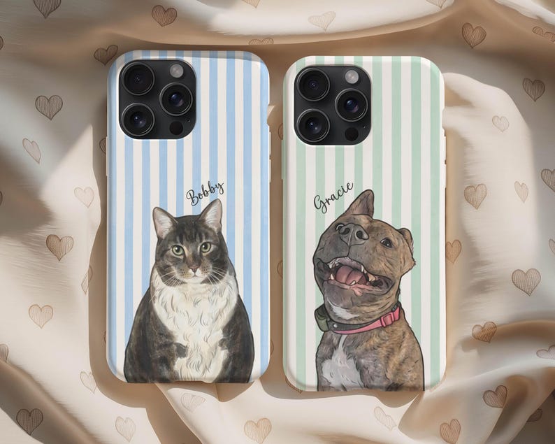 May include: Two phone cases featuring custom pet portraits. The left case has a blue striped background with a brown and white cat labeled Bobby. The right case has a green striped background with a brown brindle dog wearing a pink collar labeled Gracie.