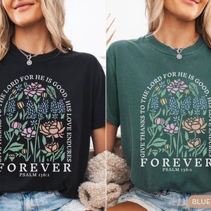 May include: Black and blue spruce t-shirts with floral designs and the text "GIVE THANKS TO THE LORD FOR HE IS GOOD, HIS LOVE ENDURES FOREVER PSALM 136:1". The shirts feature a floral arch design with various flowers.