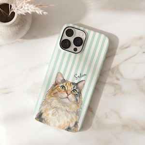 May include: A phone case featuring a light mint green and white vertical striped pattern with a watercolor-style illustration of a calico cat. The name Salem is printed in a cursive script above the cat's head, and the case has a camera cutout.