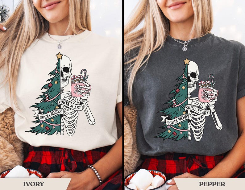 May include: Ivory and pepper-colored t-shirts with a festive, yet spooky design. The graphic features a half-skeleton, half-Christmas tree with the text "Sorta Merry Sorta Scary". The skeleton holds a mug with candy canes.