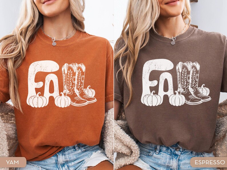 May include: Two t-shirts, one yam-colored and one espresso-colored, each featuring a white graphic. The graphic includes the word "FALL", cowboy boots, and pumpkins. The shirts are short-sleeved and have a vintage, distressed look.