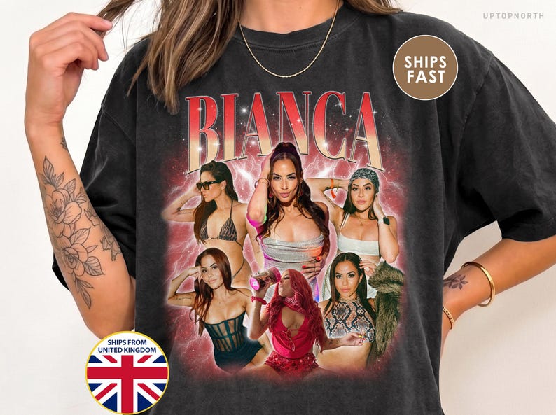 May include: A black short-sleeve t-shirt featuring a graphic print with the name BIANCA in large red and white letters. The design includes a collage of six photographs of a person in various outfits and poses, set against a red, hazy background with small white star accents.