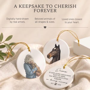 May include: Three round white ceramic ornaments with gold hanging strings. One features a person holding a puppy, one shows a horse head, and one displays the text: Emma, If love alone could have kept you here, you would have lived forever, in loving memory, 2011-2026.