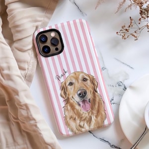 May include: A smartphone case featuring a vertical pink and white striped pattern. The case displays a detailed illustration of a golden retriever dog with its tongue out, and the name Peach is written in black cursive script above the dog.