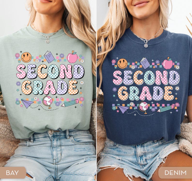 May include: Two t-shirts, one in bay green and the other in denim blue, each featuring the words "SECOND GRADE" in a colorful, retro font. The design includes a smiling face, apple, book, globe, pencil, and paper airplane. The shirts are casual and suitable for students.
