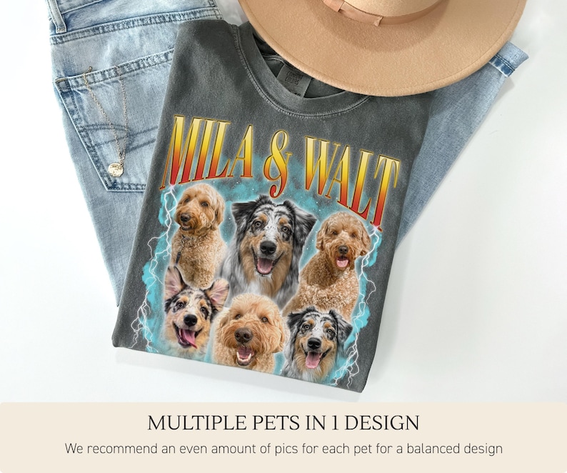 Pu&ograve; includere: Una maglietta grigio antracite con una grafica di sei cani e la scritta "MILA & WALT". La maglietta &egrave; appoggiata su jeans blu e un cappello beige. Il testo "MULTIPLE PETS IN 1 DESIGN" &egrave; in basso.