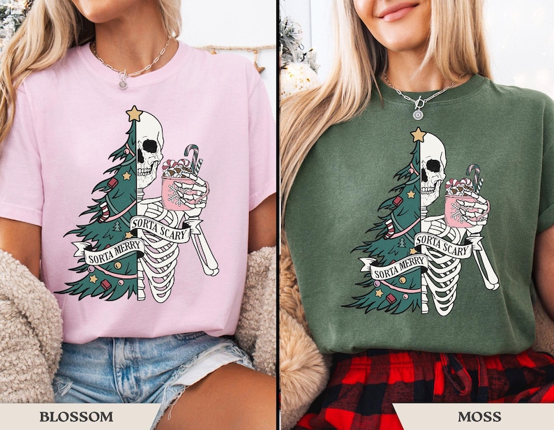 May include: Pink and green t-shirts with a skeleton graphic. The graphic features a skull, Christmas tree, and the text "Sorta Merry Sorta Scary". The skeleton holds a mug with candy canes.