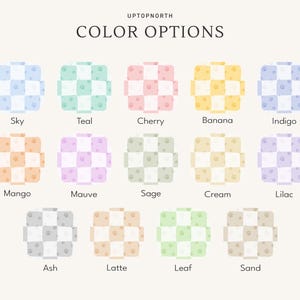 May include: A color chart titled UPTOPNORTH COLOR OPTIONS displaying fourteen square swatches in a checkerboard pattern. Each swatch features a two-tone grid with small paw print icons. Colors include Sky, Teal, Cherry, Banana, Indigo, Mango, Mauve, Sage, Cream, Lilac, Ash, Latte, Leaf, and Sand.