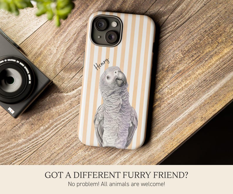 May include: A smartphone case featuring a vertical light orange and white striped pattern with a detailed illustration of a grey African parrot in the center. The name Henry is printed in black script above the parrot. The case has a black camera cutout.