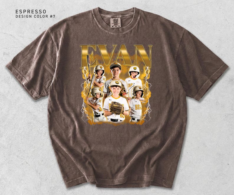 May include: Espresso-colored t-shirt featuring a baseball team photo with the name "EVAN" in gold lettering. The design includes a team photo with lightning bolt accents. The shirt has a crew neck and short sleeves.