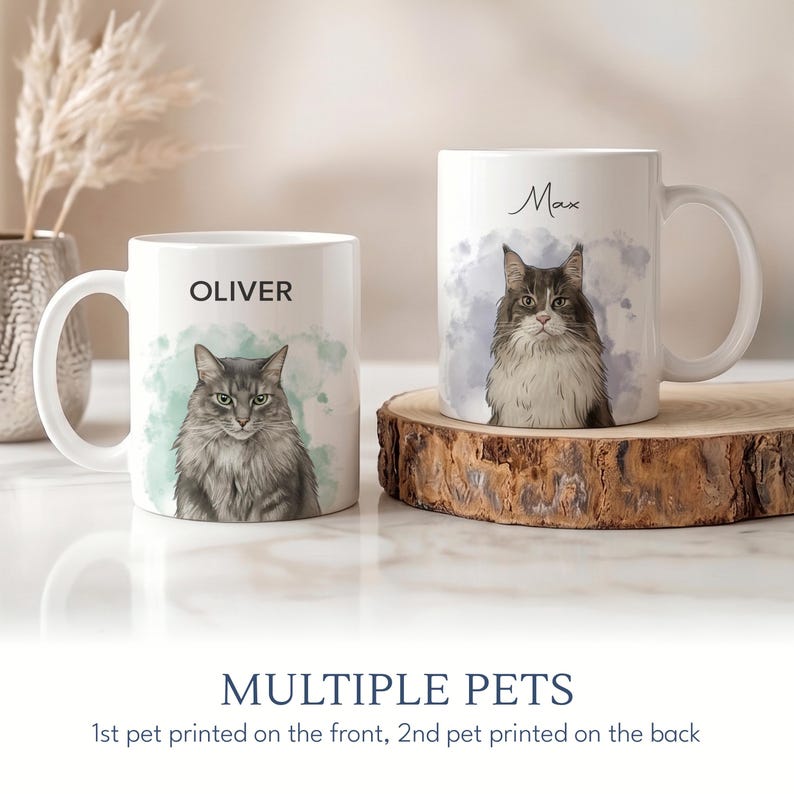 May include: Two white ceramic mugs with custom cat portraits. One mug features a gray cat with the name "OLIVER", the other a brown and white cat named "Max". The mugs have a watercolor background and the text "MULTIPLE PETS".