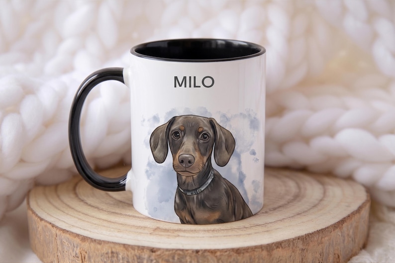May include: White ceramic mug with a black handle and rim, featuring a watercolor illustration of a dachshund dog. The dog is brown and tan with a silver collar. The name "MILO" is printed above the dog.