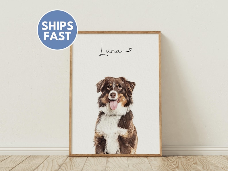 May include: A framed print of a brown and white dog with a pink tongue sticking out. The dog is looking at the camera. The print has the word 'Luna' written in cursive with a heart symbol next to it.