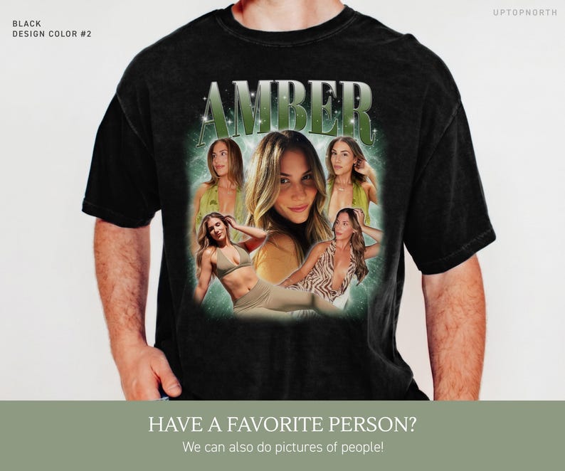 May include: A black short-sleeve t-shirt featuring a graphic print with the name AMBER in large green letters at the top. Below the name are multiple photographic images of a person in various poses, set against a glowing green background.