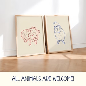May include: Two framed art prints featuring animal illustrations. One print shows a red pig with the name "FRANKIE" above it. The other print displays a blue bird with the name "BRUNO". The phrase "ALL ANIMALS ARE WELCOME!" is at the bottom.