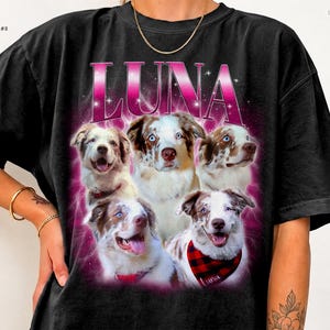 May include: A black t-shirt featuring a graphic print of five Australian Shepherd dogs. The word LUNA is printed in large pink letters above the dogs, set against a vibrant pink glowing background with small star accents.