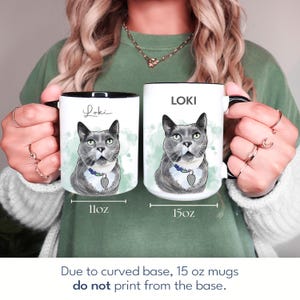 May include: Two white ceramic mugs with black rims and handles, featuring a gray cat portrait with the name "Loki." One mug is 11oz, the other is 15oz. The text "Due to curved base, 15 oz mugs do not print from the base" is at the bottom.