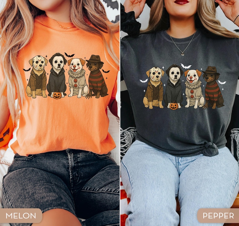 May include: Two t-shirts, one melon and one pepper, each featuring a graphic of four dogs dressed as horror movie characters. The dogs are sitting in a row with a small pumpkin in front of them, with bats in the background.
