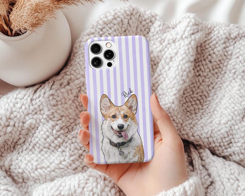 May include: A phone case with a vertical striped pattern in white and lavender. The case features a portrait of a Corgi dog with the name "Rick" written above the dog. The dog is wearing a collar with a tag.
