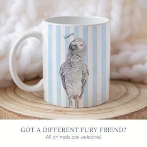 May include: A white ceramic mug featuring a vertical light blue and white striped pattern. The mug displays a detailed illustration of a grey African Grey parrot with the name Henry written in black script above the bird's head.