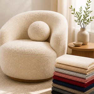 May include: A cream-colored boucle armchair with a matching round pillow. The image showcases a stack of fabric swatches in various colors, including ivory, beige, and burgundy. Text reads "Boucle Upholstery Fabric."