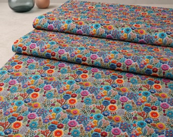 May include: A folded length of fabric featuring a dense, colorful floral embroidery pattern. The design includes vibrant red, orange, yellow, pink, and blue flowers with green stems and leaves on a neutral background, creating a textured surface.