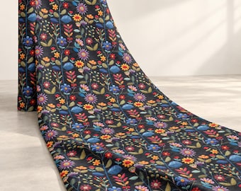 May include: A roll of black fabric featuring a repeating pattern of embroidered flowers and leaves in vibrant shades of blue, orange, yellow, purple, and green. The design consists of vertical stems with various floral shapes and foliage.