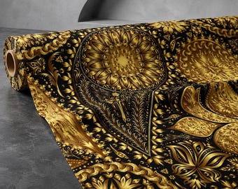 May include: A roll of fabric featuring a repeating pattern of intricate gold floral and paisley motifs set against a deep black background. The design includes circular mandala-like elements and ornate swirling filigree details across the surface.