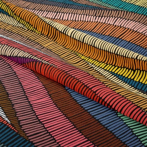 May include: A colorful fabric with a wavy pattern of black lines and colorful dashes. The fabric is folded in half, showing the pattern on both sides.