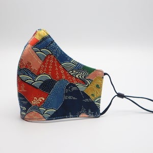 May include: A blue, red, and yellow face mask with a Japanese-inspired mountain and wave pattern.