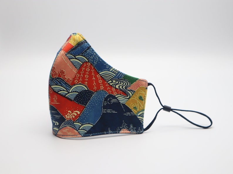 May include: A blue, red, and yellow face mask with a Japanese-inspired mountain and wave pattern.