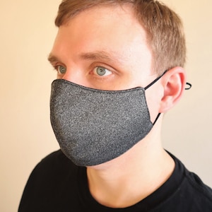 The male model is wearing a medium size Charcoal Gray face mask. Available in reversible or with filter pocket option.