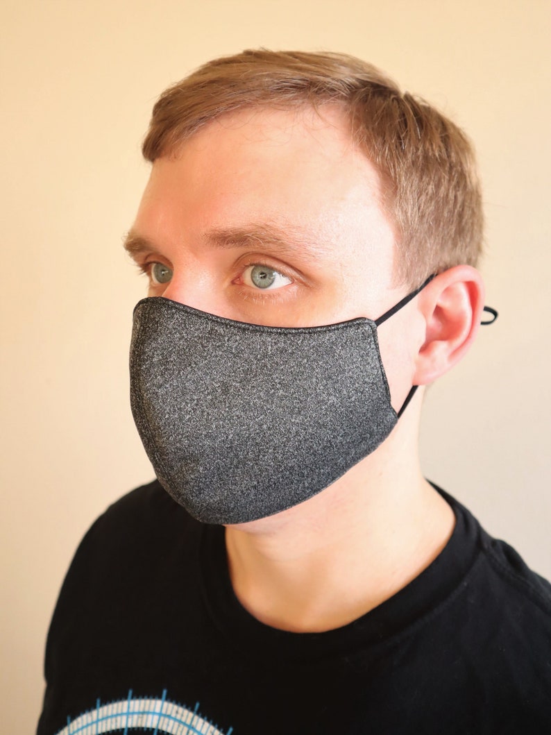 The male model is wearing a medium size Charcoal Gray face mask. Available in reversible or with filter pocket option.