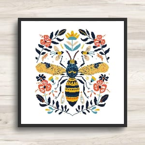 May include: A framed art print featuring a stylized bee design. The bee is depicted with yellow and blue details, surrounded by floral and leaf elements in shades of red, blue, and yellow. The artwork is set against a white background.