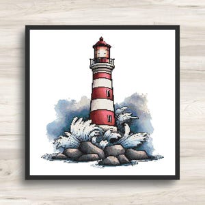 May include: A cross-stitch design of a lighthouse with red and white stripes, a red top, and small windows. The lighthouse is set on a rocky base with crashing waves and a blue-gray background. The artwork is framed in a black square.