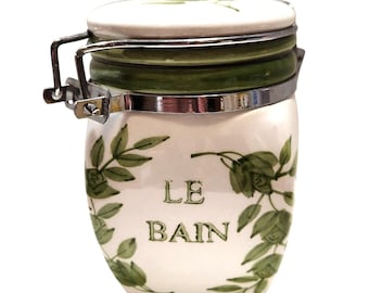 Tarro de cerámica vintage Le Bain con diseño de hojas y tapa de metal con cierre.