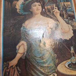 May include: Vintage advertisement featuring a woman in a blue dress and hat, holding a glass of dark liquid. The artwork has a classic, old-fashioned style, with a bar scene in the background and a bottle of Pepsi on a table.