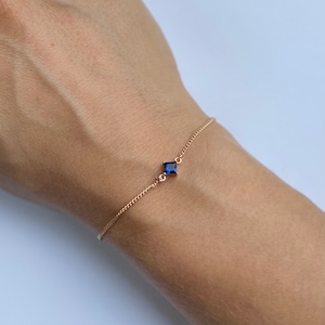 Elegant, dainty gold plated chain bracelet with pretty blue diamond shaped charm