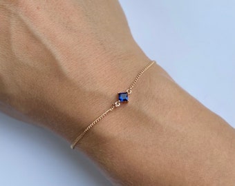 Elegant, dainty gold plated chain bracelet with pretty blue diamond shaped charm