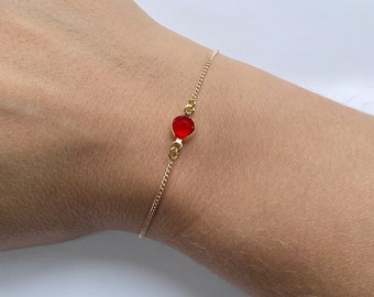 Elegant, dainty gold plated chain bracelet with pretty red coloured cubic zirconia charm, Ruby, July birthstone.