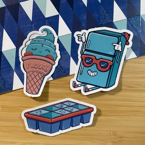 May include: Three cartoon stickers featuring a blue ice cream cone with the word "FROSTY" on it, a blue refrigerator wearing sunglasses, and a blue ice cube tray with six ice cubes.