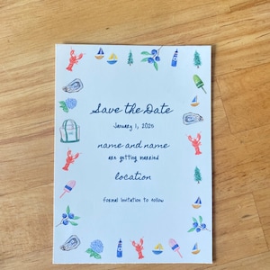 May include: A white Save the Date card with hand-drawn illustrations of nautical elements like sailboats, lobsters, and a lighthouse. The text includes the date January 1, 2025, and space for names and location.