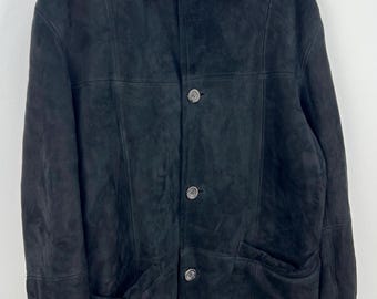 May include: A black suede coat with a faux fur collar. The coat has a button-up front, two front pockets, and a tailored fit. The coat is hanging on a wooden hanger against a white background.