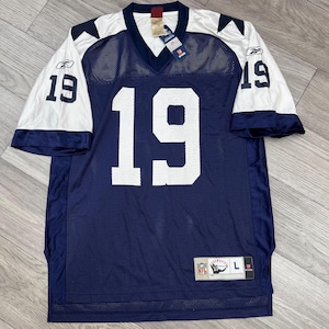 Pode incluir: Uma camisa de futebol americano Reebok azul com detalhes brancos e o número 19 na frente. A camisa é tamanho L e tem o logotipo da NFL na parte inferior direita.