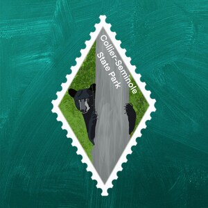 May include: A white diamond-shaped stamp with a black bear peeking out from behind a tree. The stamp says "Collier-Seminole State Park".