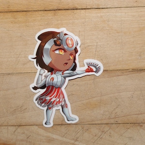 May include: A sticker featuring a cartoon character in a warrior-like outfit. The character has brown skin, brown hair, and is wearing silver and red armor. The character is holding a red and silver weapon, with a determined expression.
