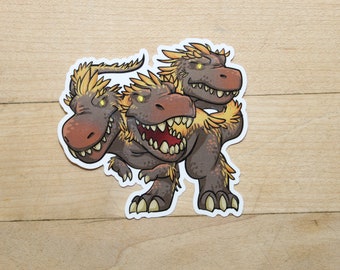 May include: A cartoon sticker of a three-headed dinosaur with a brown body and yellow mane. The dinosaur has a toothy grin and is standing on all fours.